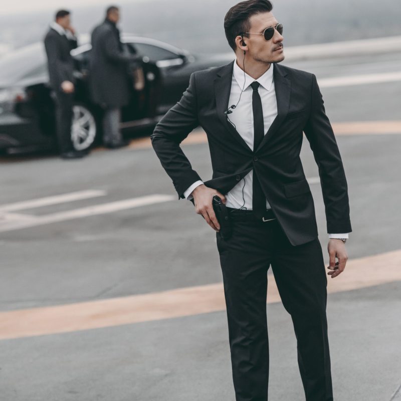 handsome bodyguard with security earpiece and gun handsome bodyguard with security earpiece and gun